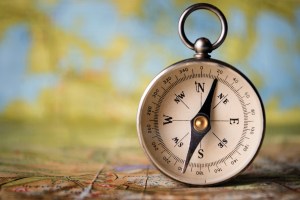 Magnetic compass on a world map